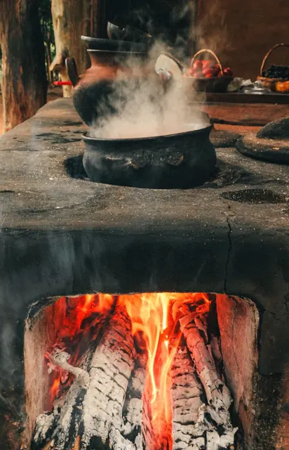 Fogón de leña con una olla de barro humeando
